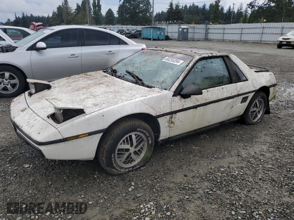 1984 Pontiac Fiero z VIN 1G2AF37R6EP320306, wystawiony jako Copart lot #68255394 z przebiegiem 49 284 mil mil oraz Czysty tytuł • Clean title. Historia ofert i sprzedaży dostępna na DreamBid. Obrazek 1.