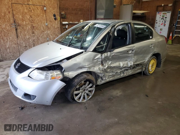 2010 Suzuki SX4 with VIN JS2YC5A49A6310256, listed as a Copart auction lot 73210584 with 135,021 mi miles and Salvage Title. Bid and sale history available at DreamBid. Image 1.