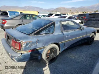 1986 Toyota Supra z VIN JT2MA70L2G0012221, wystawiony jako Copart lot #87328804 z przebiegiem 142 252 mil mil oraz Szkoda całkowita • Salvage title. Historia ofert i sprzedaży dostępna na DreamBid. Obrazek 3.