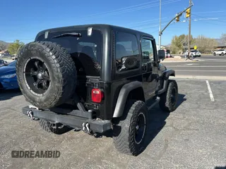 2002 Jeep Wrangler Sport with VIN 1J4FA49S32P765579, listed as a Copart auction lot 55244845 with 127,791 mi miles and Clean Title. Bid and sale history available at carsss.com. Image 4.
