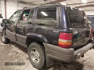 1997 Jeep Grand Cherokee Laredo with VIN 1J4GZ58S8VC675487, listed as a IAAI auction lot 41034046 with 243,284 mi miles. Bid and sale history available at carsss.com. Image 3.