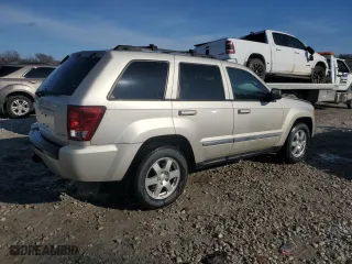 2010 Jeep Grand Cherokee Laredo with VIN 1J4RR4GT1AC106990, listed as a Copart auction lot 87421664 with 106,025 mi miles and Salvage Title. Bid and sale history available at carsss.com. Image 3.