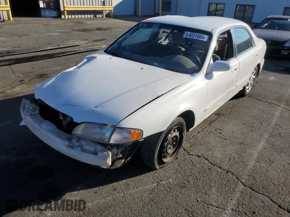 1999 Mazda 626 LX z VIN 1YVGF22D4X5882600, wystawiony jako Copart lot #69031604 z przebiegiem Nie podano mil oraz Szkoda całkowita • Salvage title. Historia ofert i sprzedaży dostępna na DreamBid. Obrazek 1.