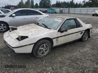 1984 Pontiac Fiero z VIN 1G2AF37R6EP320306, wystawiony jako Copart lot #68255394 z przebiegiem 49 284 mil mil oraz Tytuł czysty. Historia ofert i sprzedaży dostępna na DreamBid. Obrazek 1.