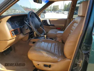 1998 Jeep Grand Cherokee with VIN 1J4FX48S8WC281615, listed as a Copart auction lot 77305594 with 128,393 mi miles and Salvage title. Bid and sale history available at DreamBid. Image 7.