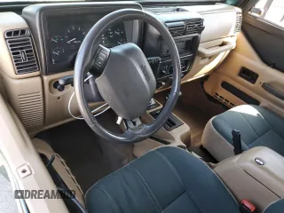 2000 Jeep Wrangler Sahara z VIN 1J4FA59S1YP746043, wystawiony jako Copart lot #58842665 z przebiegiem 148 348 mil mil oraz Szkoda całkowita • Salvage title. Historia ofert i sprzedaży dostępna na DreamBid. Obrazek 8.