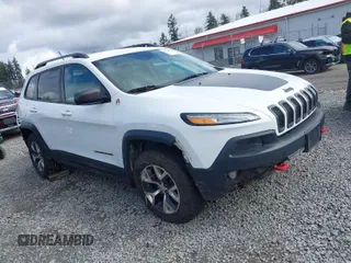 2015 Jeep Cherokee Trailhawk z VIN 1C4PJMBS4FW757314, wystawiony jako IAAI lot #41916722 z przebiegiem 140 110 mil mil oraz . Historia ofert i sprzedaży dostępna na DreamBid. Obrazek 1.