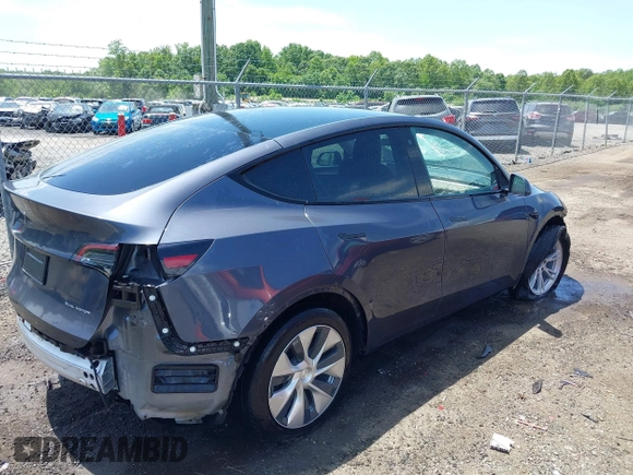 2023 Tesla Model Y Long Range with VIN 7SAYGAEE7PF615751, listed as a IAAI auction lot 42297819 with 31,201 mi miles and . Bid and sale history available at DreamBid. Image 4.