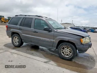 2003 Jeep Grand Cherokee Laredo with VIN 1J4GW48SX3C569087, listed as a Copart auction lot 55941035 with Not provided miles and Salvage title. Bid and sale history available at DreamBid. Image 4.
