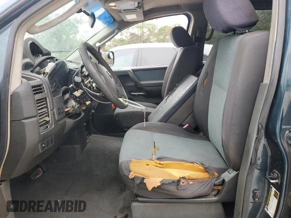 2006 Nissan Titan LE z VIN 1N6BA07B16N557411, wystawiony jako Copart lot #86058634 z przebiegiem 263 198 mil mil oraz Szkody całkowita. Historia ofert i sprzedaży dostępna na DreamBid. Obrazek 7.