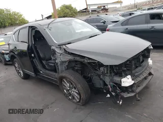 2020 Mazda CX-5 Grand Touring with VIN JM3KFADM7L0779452, listed as a IAAI auction lot 42676444 with 63,036 mi miles and . Bid and sale history available at DreamBid. Image 1.