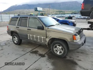 1996 Jeep Grand Cherokee Laredo with VIN 1J4GZ58S3TC245928, listed as a Copart auction lot 57313735 with 165,733 mi miles and Salvage title. Bid and sale history available at DreamBid. Image 4.