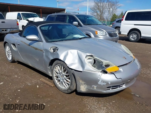 1999 Porsche Boxster z VIN WP0CA2989XU627152, wystawiony jako IAAI lot #41805432 z przebiegiem 112 380 mil mil oraz . Historia ofert i sprzedaży dostępna na DreamBid. Obrazek 1.