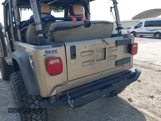 2005 Jeep Wrangler SE with VIN 1J4FA29S25P328827, listed as a IAAI auction lot 41917807 with 157,562 mi miles. Bid and sale history available at carsss.com. Image 6.