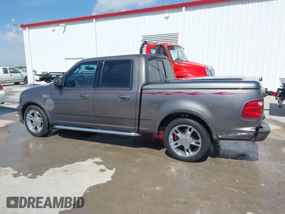 2002 Ford F-150 Harley Davidson with VIN 1FTRW07392KE11409, listed as a IAAI auction lot 41877998 with 148,476 mi miles. Bid and sale history available at carsss.com. Image 14.