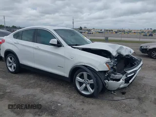 2015 BMW X4 xDrive28i with VIN 5UXXW3C55F0M87113, listed as a IAAI auction lot 41645810 with 148,179 mi miles. Bid and sale history available at carsss.com. Image 1.