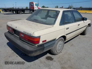 1987 Toyota Camry z VIN JT2SV21EXH3130273, wystawiony jako IAAI lot #42472806 z przebiegiem 124 958 mil mil oraz . Historia ofert i sprzedaży dostępna na DreamBid. Obrazek 4.