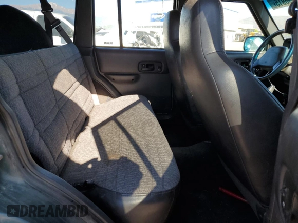 2000 Jeep Cherokee with VIN 1J4FF48S0YL198802, listed as a Copart auction lot 59996915 with 249,756 mi miles and Salvage title. Bid and sale history available at DreamBid. Image 10.