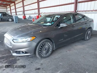2013 Ford Fusion Titanium Hybrid with VIN 3FA6P0RU0DR277092, listed as a IAAI auction lot 41811079 with 123,071 mi miles. Bid and sale history available at carsss.com. Image 2.