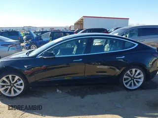 2018 Tesla Model 3 Long Range Battery with VIN 5YJ3E1EA2JF014975, listed as a IAAI auction lot 41319407 with 106,301 mi miles and . Bid and sale history available at DreamBid. Image 14.