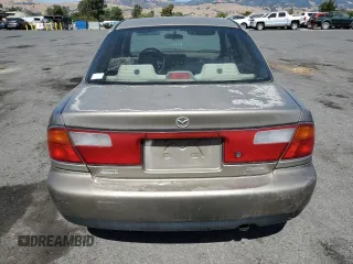 1998 Mazda Protege DX z VIN JM1BC1414W0203670, wystawiony jako Copart lot #62966544 z przebiegiem 249 405 mil mil oraz Szkoda całkowita • Salvage title. Historia ofert i sprzedaży dostępna na DreamBid. Obrazek 6.
