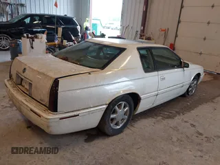 2001 Cadillac Eldorado Touring ETC z VIN 1G6ET12951B101641, wystawiony jako IAAI lot #42274235 z przebiegiem 119 965 mil mil oraz . Historia ofert i sprzedaży dostępna na DreamBid. Obrazek 4.