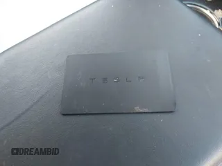 2018 Tesla Model 3 Long Range Battery with VIN 5YJ3E1EBXJF055203, listed as a IAAI auction lot 42019770 with 57,379 mi miles and . Bid and sale history available at DreamBid. Image 11.
