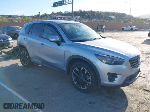 2016 Mazda CX-5 Grand Touring z VIN JM3KE2DY8G0709573, wystawiony jako IAAI lot #42021005 z przebiegiem 113 941 mil mil oraz . Historia ofert i sprzedaży dostępna na DreamBid. Obrazek 1.