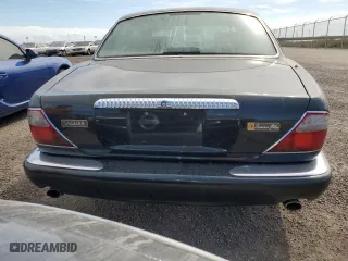 1999 Jaguar XJ with VIN SAJKX6047XC861227, listed as a Copart auction lot 75007414 with 0 mi miles and Salvage Title. Bid and sale history available at carsss.com. Image 6.