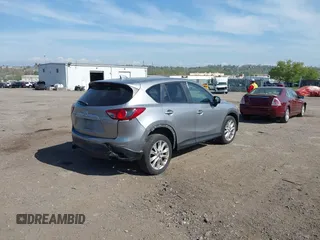 2014 Mazda CX-5 Grand Touring with VIN JM3KE4DY7E0311893, listed as a IAAI auction lot 42090872 with 102,154 mi miles and . Bid and sale history available at DreamBid. Image 4.