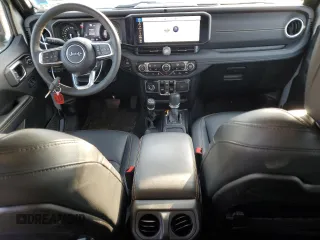 2024 Jeep Wrangler Sahara with VIN 1C4RJXP60RW128448, listed as a Copart auction lot 48658135 with 5,879 mi miles and Salvage Title. Bid and sale history available at DreamBid. Image 8.