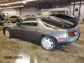 1984 Porsche 928 z VIN WP0JB0925ES861303, wystawiony jako Copart lot #41979575 z przebiegiem 114 593 mil mil oraz Nie do naprawy. Historia ofert i sprzedaży dostępna na DreamBid. Obrazek 2.