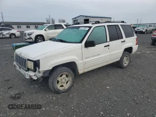 1998 Jeep Grand Cherokee Laredo with VIN 1J4GZ48S1WC165851, listed as a Copart auction lot 84110044 with 306,484 mi miles and Salvage Title. Bid and sale history available at carsss.com. Image 1.