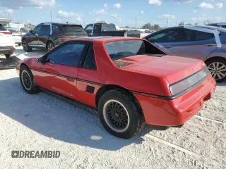 1988 Pontiac Fiero z VIN 1G2PE11R1JP219470, wystawiony jako Copart lot #77772864 z przebiegiem 94 011 mil mil oraz Szkody całkowita. Historia ofert i sprzedaży dostępna na DreamBid. Obrazek 2.
