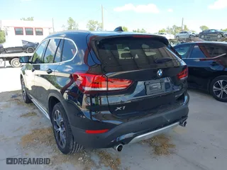 2021 BMW X1 sDrive28i with VIN WBXJG7C02M5S59010, listed as a IAAI auction lot 41933532 with 49,207 mi miles. Bid and sale history available at carsss.com. Image 3.
