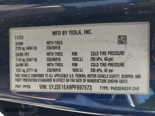 2023 Tesla Model 3 with VIN 5YJ3E1EA9PF697573, listed as a IAAI auction lot 41173833 with 6,966 mi miles. Bid and sale history available at carsss.com. Image 9.