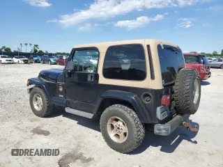 2001 Jeep Wrangler Sahara with VIN 1J4FA59S71P343366, listed as a Copart auction lot 57826405 with 156,436 mi miles and Salvage title. Bid and sale history available at DreamBid. Image 2.