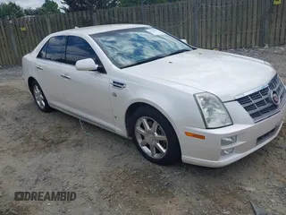 2010 Cadillac STS AWD z VIN 1G6DU6EV4A0102872, wystawiony jako IAAI lot #42348505 z przebiegiem 151 934 mil mil oraz . Historia ofert i sprzedaży dostępna na DreamBid. Obrazek 1.