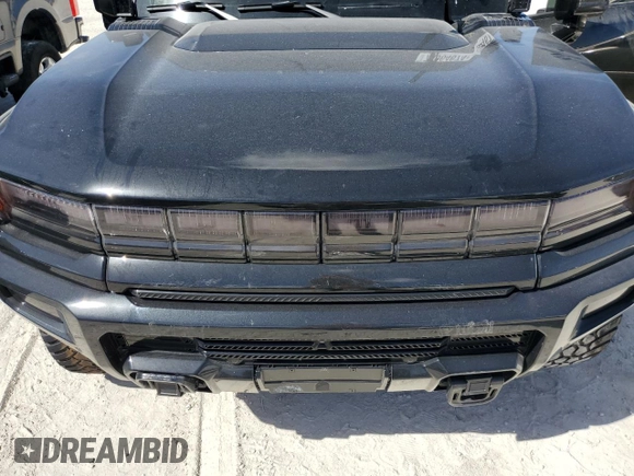2024 GMC Hummer EV 3X z VIN 1GKB0RDC4RU103837, wystawiony jako Copart lot #76064674 z przebiegiem Nie podano mil oraz Nie do naprawy. Historia ofert i sprzedaży dostępna na DreamBid. Obrazek 11.