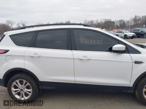2018 Ford Escape SE z VIN 1FMCU9GD2JUC77186, wystawiony jako IAAI lot #41308133 z przebiegiem 123 156 mil mil oraz . Historia ofert i sprzedaży dostępna na DreamBid. Obrazek 13.