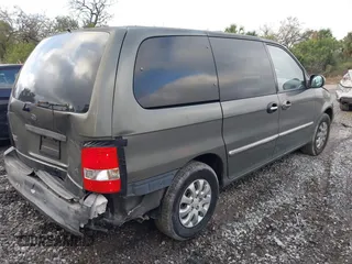 2004 Kia Sedona LX with VIN KNDUP131346533373, listed as a IAAI auction lot 41632342 with 76,545 mi miles. Bid and sale history available at carsss.com. Image 4.