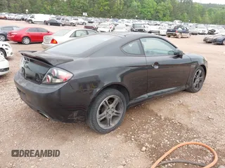 2007 Hyundai Tiburon GT z VIN KMHHN66F37U250320, wystawiony jako IAAI lot #42047654 z przebiegiem 231 899 mil mil oraz . Historia ofert i sprzedaży dostępna na DreamBid. Obrazek 4.