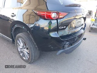 2020 Mazda CX-5 Grand Touring z VIN JM3KFADMXL0740144, wystawiony jako IAAI lot #41830203 z przebiegiem 70 535 mil mil oraz . Historia ofert i sprzedaży dostępna na DreamBid. Obrazek 6.