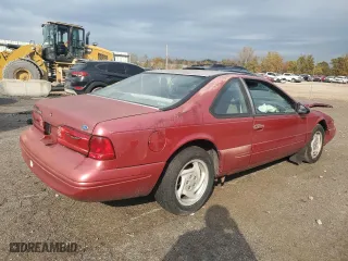 1996 Ford Thunderbird LX with VIN 1FALP62W7TH135632, listed as a Copart auction lot 77134024 with 128,931 mi miles and Salvage Title. Bid and sale history available at carsss.com. Image 3.