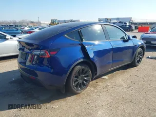 2021 Tesla Model Y Standard Range with VIN 5YJYGDED5MF121874, listed as a IAAI auction lot 41238170 with 72,041 mi miles and . Bid and sale history available at DreamBid. Image 4.