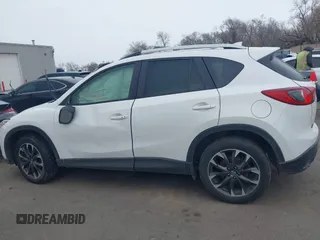 2016 Mazda CX-5 Grand Touring z VIN JM3KE2DY8G0885006, wystawiony jako IAAI lot #41615873 z przebiegiem 118 890 mil mil oraz . Historia ofert i sprzedaży dostępna na DreamBid. Obrazek 14.