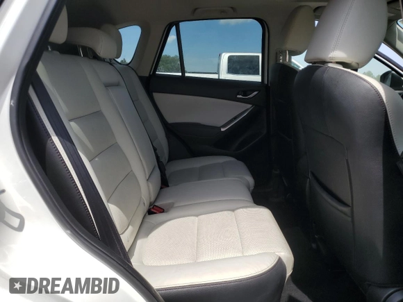 2016 Mazda CX-5 Grand Touring z VIN JM3KE2DYXG0731462, wystawiony jako Copart lot #58220465 z przebiegiem 130 033 mil mil oraz Szkoda całkowita • Salvage title. Historia ofert i sprzedaży dostępna na DreamBid. Obrazek 11.