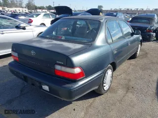 1997 Toyota Corolla with VIN 1NXBA02E5VZ595972, listed as a IAAI auction lot 41622050 with 143,577 mi miles. Bid and sale history available at carsss.com. Image 4.