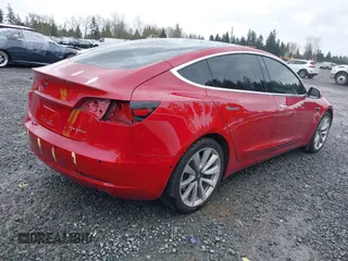 2018 Tesla Model 3 Long Range Battery z VIN 5YJ3E1EB2JF087823, wystawiony jako IAAI lot #41903609 z przebiegiem 69 749 mil mil oraz . Historia ofert i sprzedaży dostępna na DreamBid. Obrazek 4.