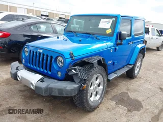 2015 Jeep Wrangler Sahara with VIN 1C4AJWBG9FL663959, listed as a IAAI auction lot 42133900 with 56,253 mi miles and . Bid and sale history available at DreamBid. Image 2.